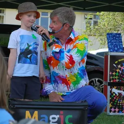 Children's entertainer twisting a balloon sword