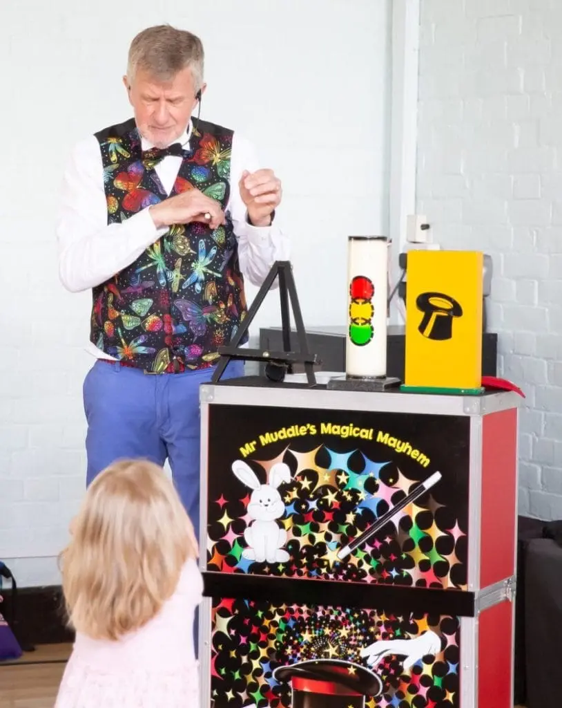 Kids' party entertainer with colourful magic props